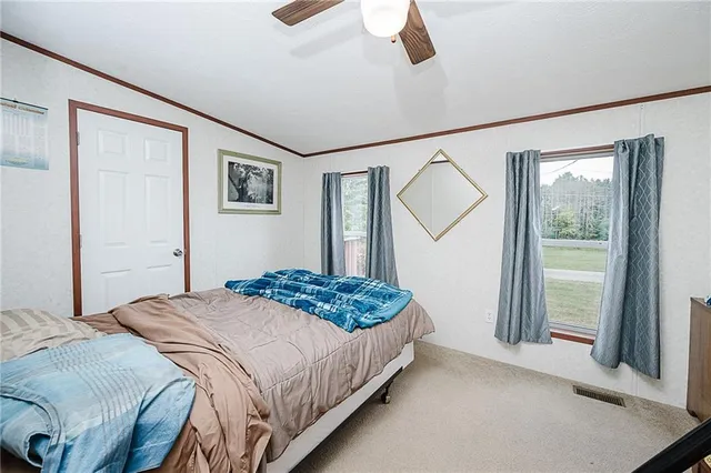 a bedroom with a bed and a large mirror