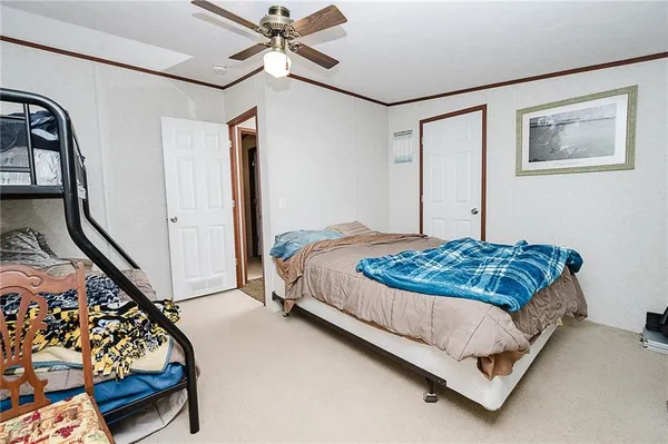 a bedroom with a bed couch and window