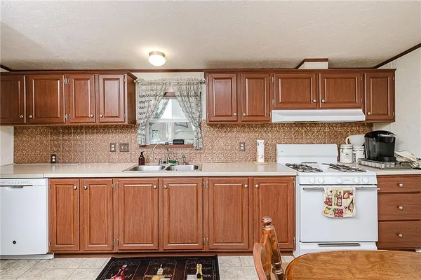 a kitchen with a sink cabinets and window