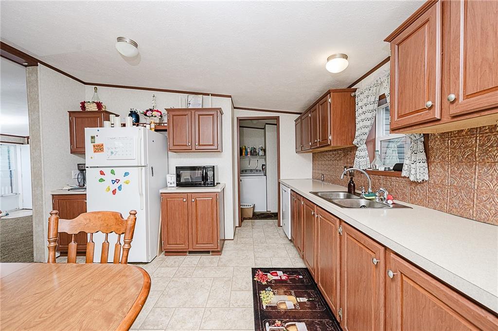 1171 Churchill Road Marion Center, PA 15759 - Photo 17 of 28 a kitchen with stainless steel appliances granite countertop a sink and cabinets