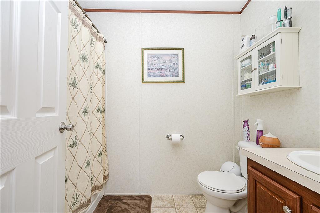 1171 Churchill Road Marion Center, PA 15759 - Photo 7 of 28 a bathroom with a toilet and a shower curtain