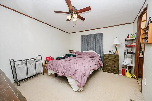 a bed room with a bed window and a chandelier
