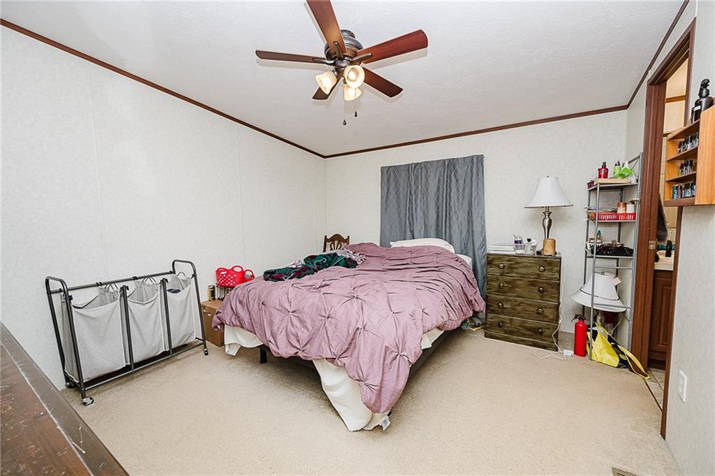 1171 Churchill Road Marion Center, PA 15759 - Photo 9 of 28 a bed room with a bed window and a chandelier