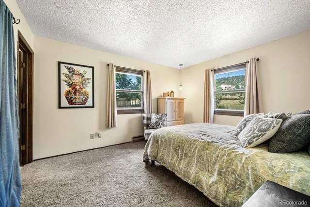 a bedroom with a large bed and a window