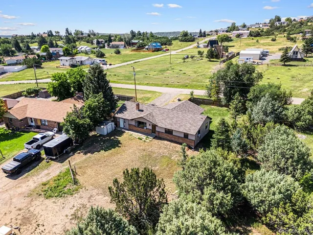 an aerial view of residential houses with outdoor space and lake view