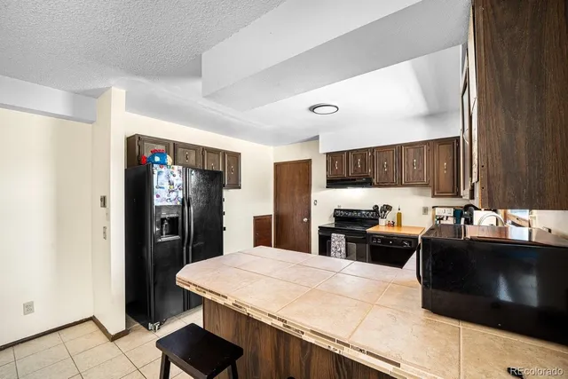 a kitchen with stainless steel appliances a stove refrigerator sink and cabinets