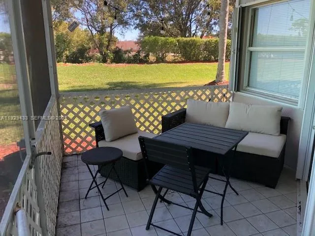 a view of a patio with lounge chairs