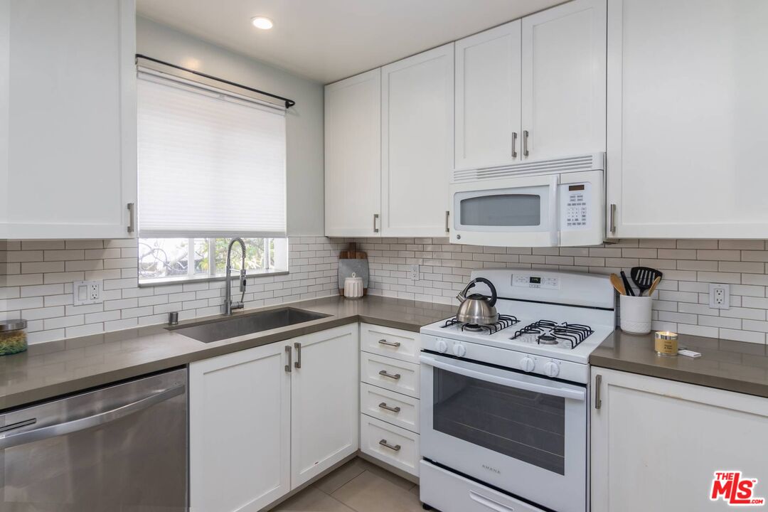 1524 Franklin Street, Unit B Santa Monica, CA 90404 - Photo 6 of 12 a kitchen with white cabinets sink and appliances