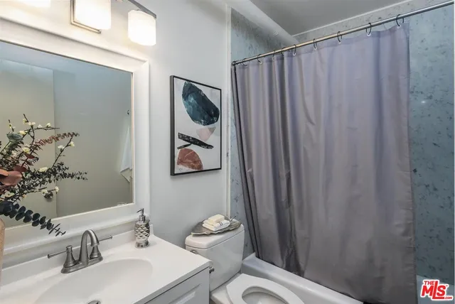 a bathroom with a sink a mirror and a toilet