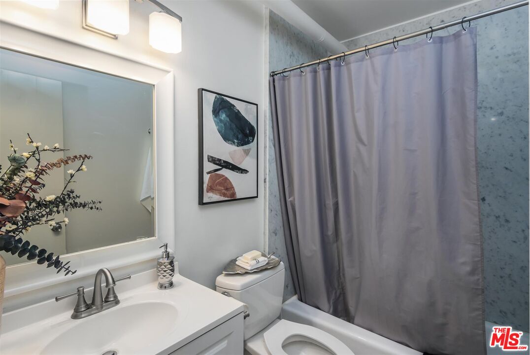 1524 Franklin Street, Unit B Santa Monica, CA 90404 - Photo 10 of 12 a bathroom with a sink a mirror and a toilet