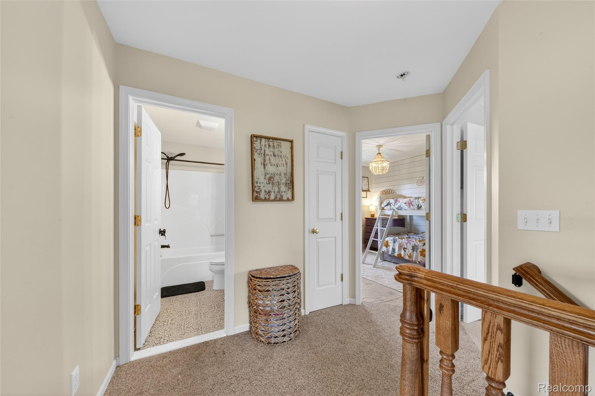 9191 Judd Road Fowlerville, MI 48836 - Photo 43 of 74 Upper-level hallway with neutral wall paint and carpeted flooring