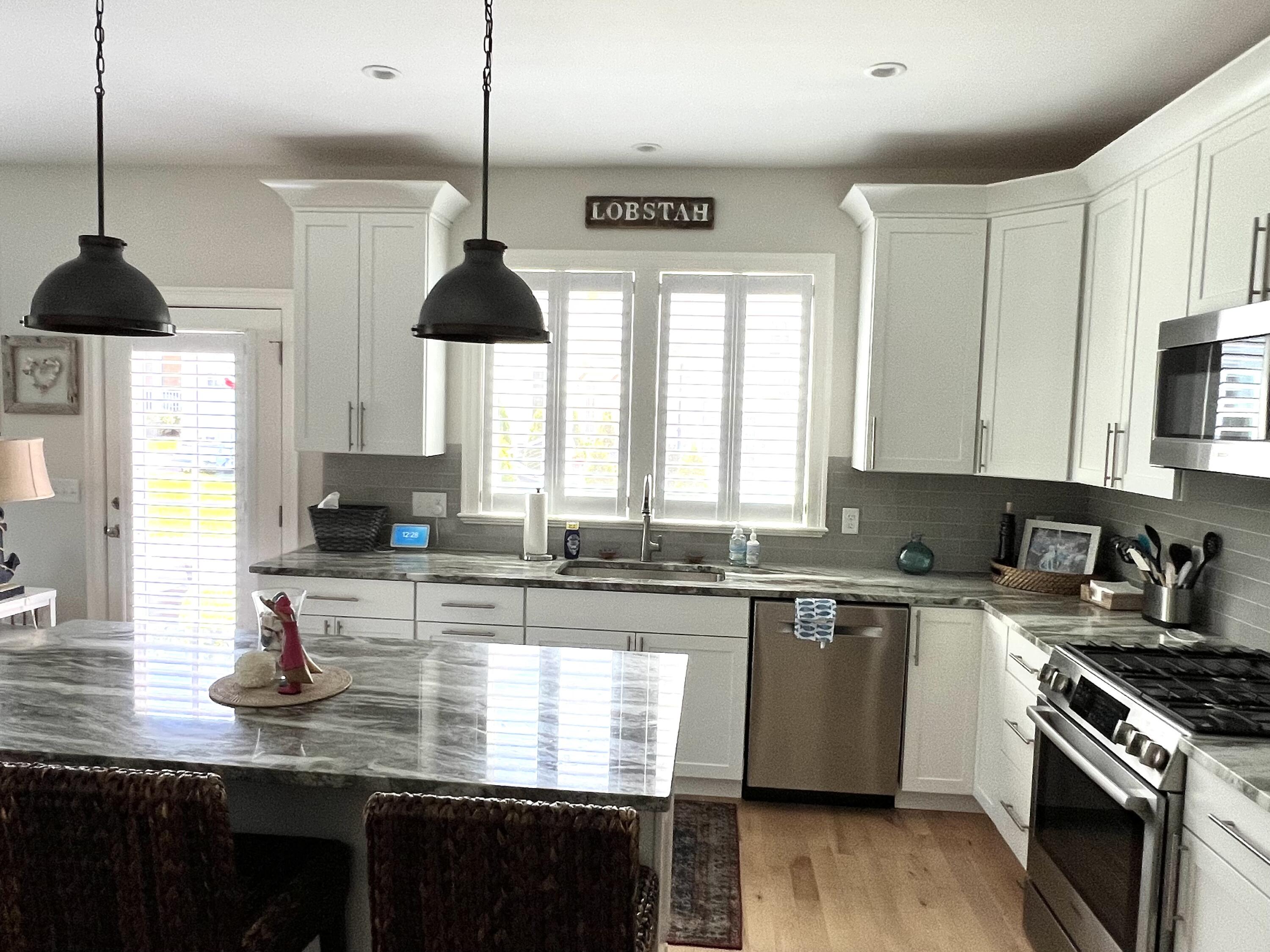 601 Ma Route, Unit 27 Dennis, MA 02638 - Photo 13 of 34 a kitchen with stainless steel appliances granite countertop a sink a stove and cabinets