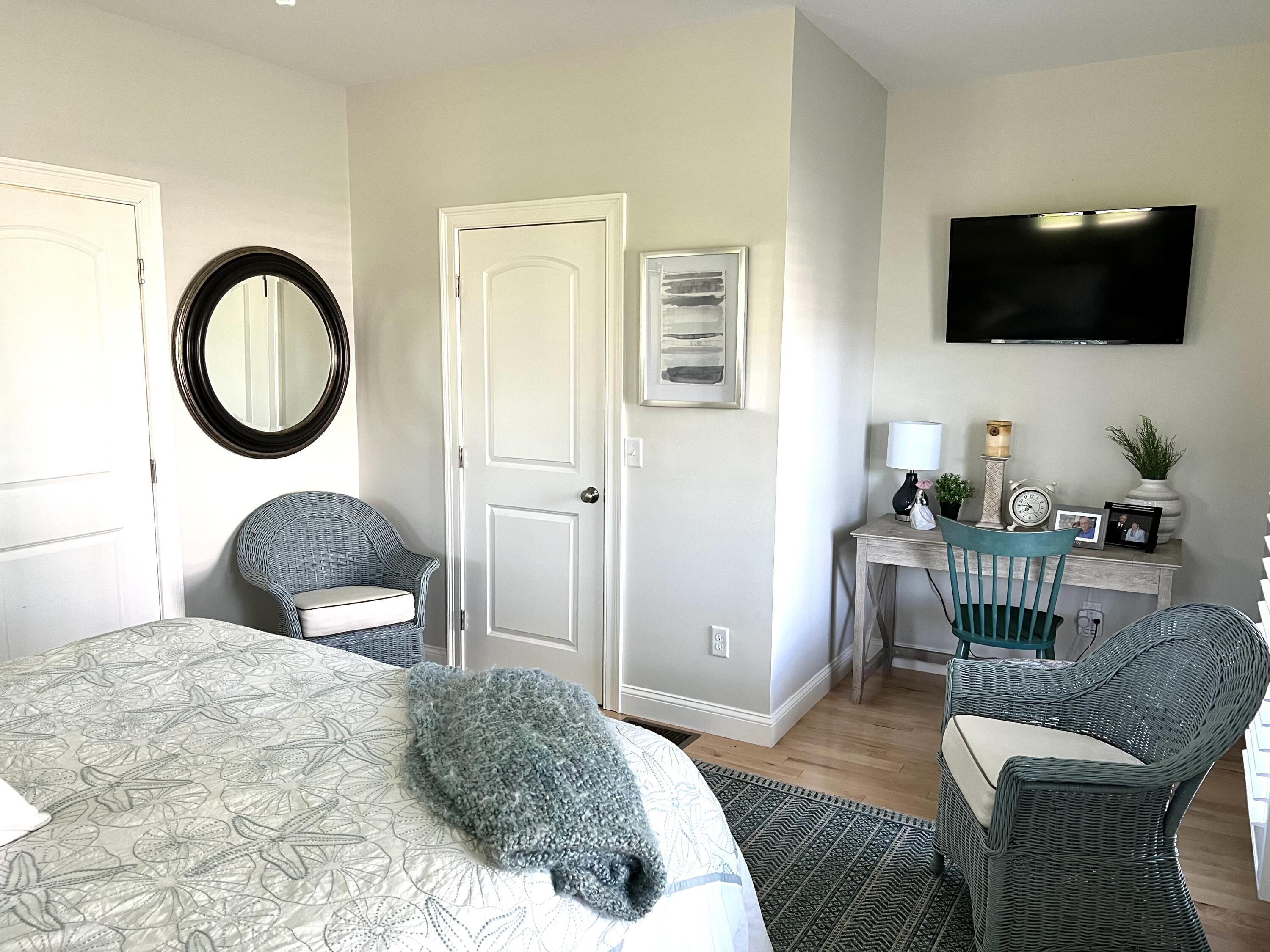 601 Ma Route, Unit 27 Dennis, MA 02638 - Photo 17 of 34 a bedroom with a bed and a flat screen tv