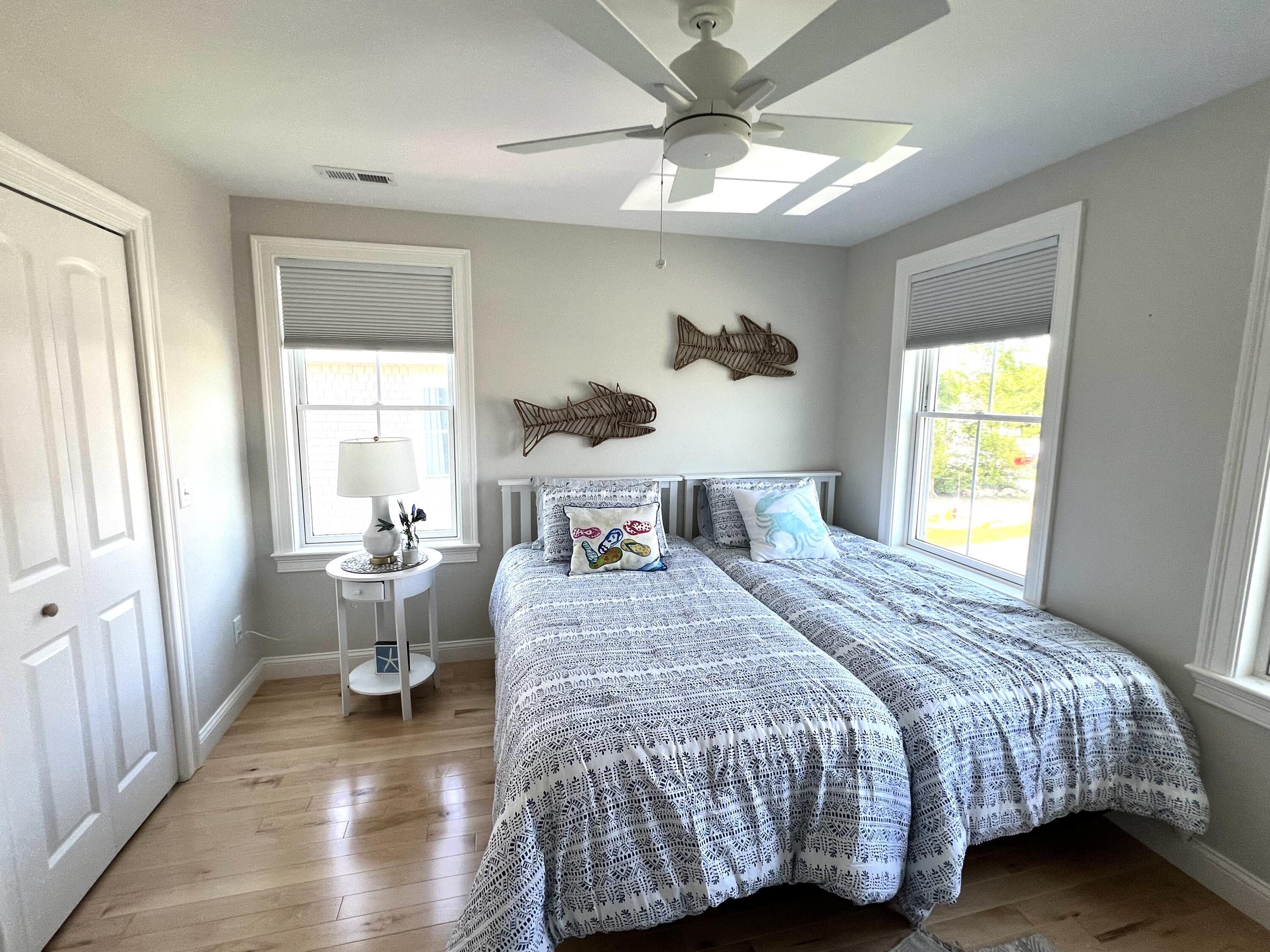 601 Ma Route, Unit 27 Dennis, MA 02638 - Photo 23 of 34 a bedroom with a bed and wooden floor