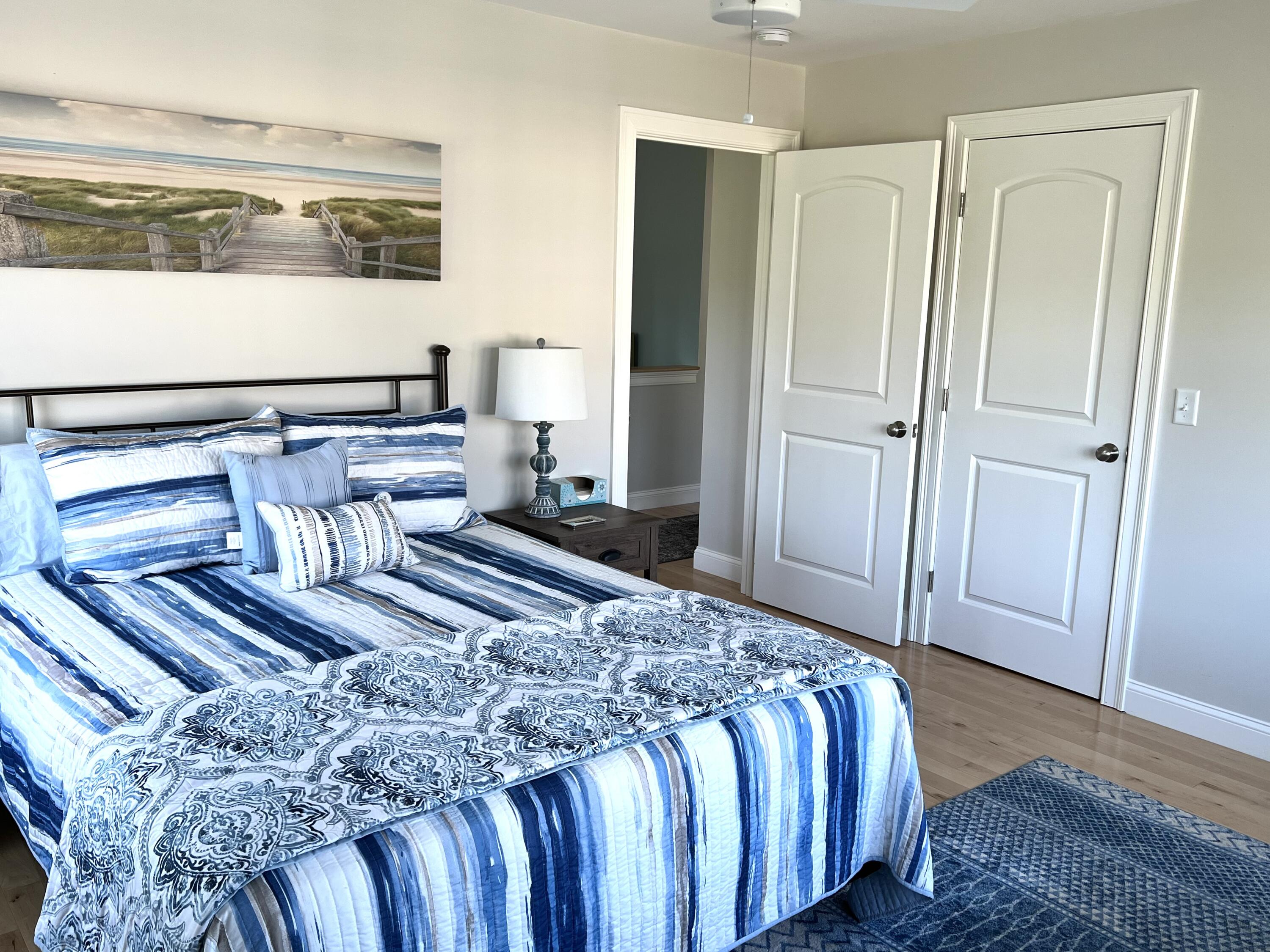 601 Ma Route, Unit 27 Dennis, MA 02638 - Photo 25 of 34 a bedroom with a bed and wooden floor