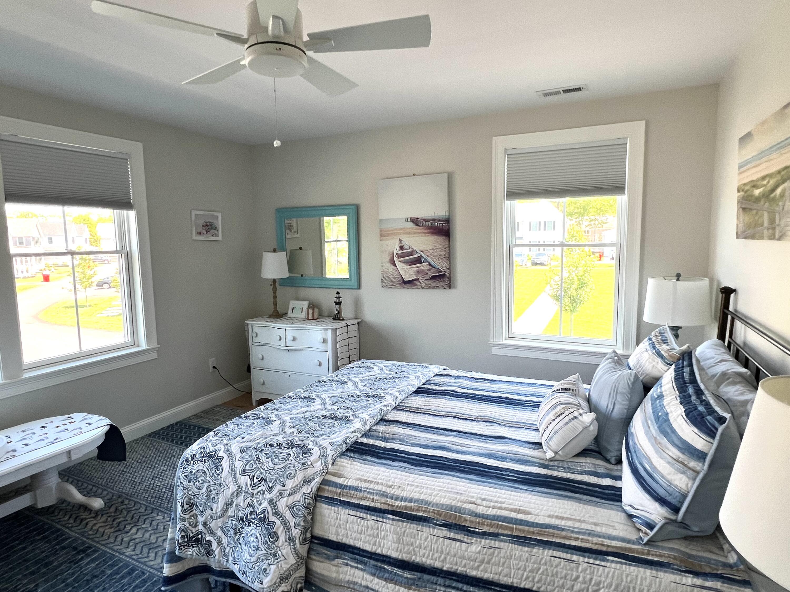 601 Ma Route, Unit 27 Dennis, MA 02638 - Photo 26 of 34 a bedroom with a bed and wooden floor