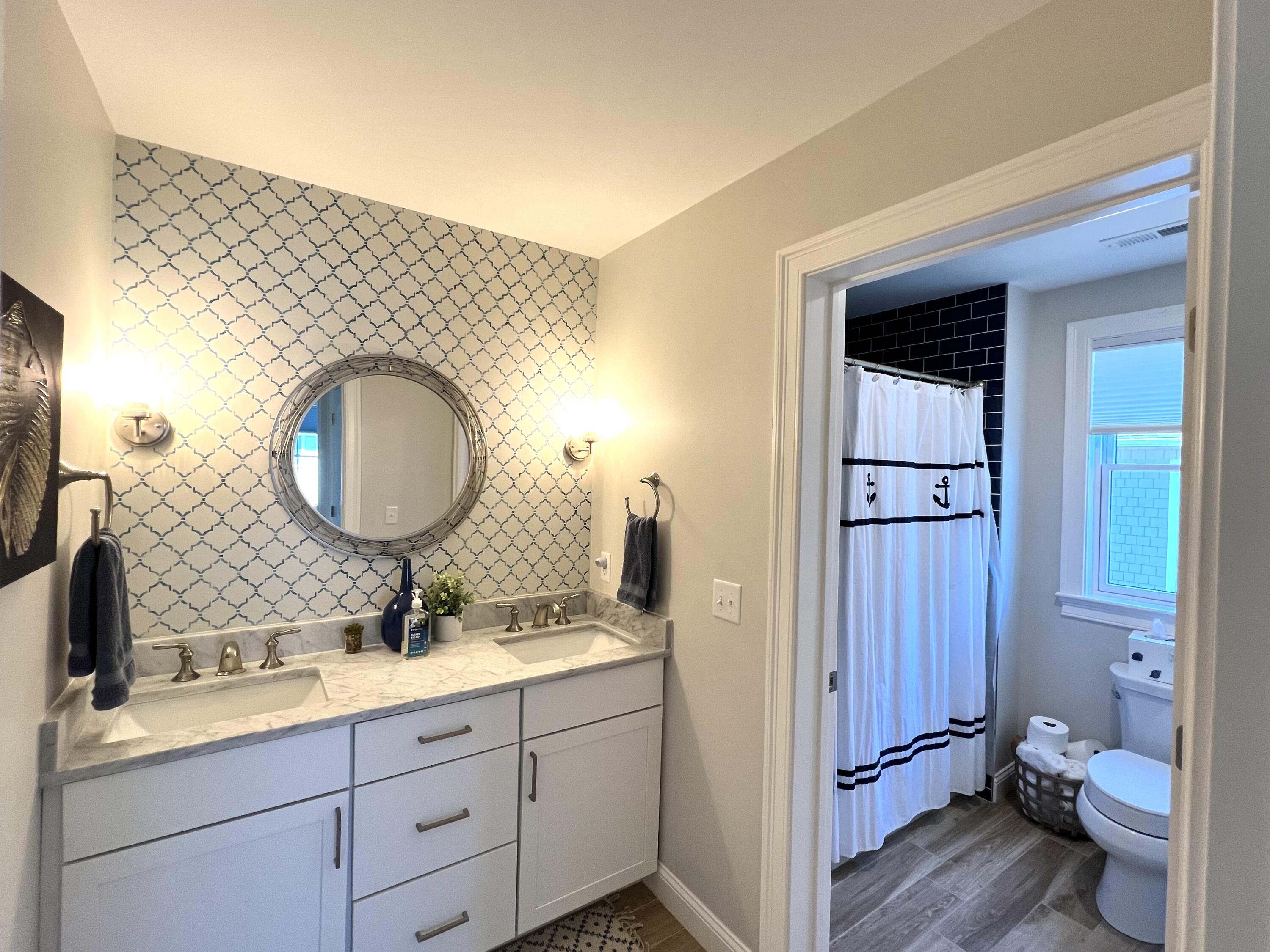 601 Ma Route, Unit 27 Dennis, MA 02638 - Photo 27 of 34 a en suite bathroom with a double vanity sink toilet mirror and bathtub