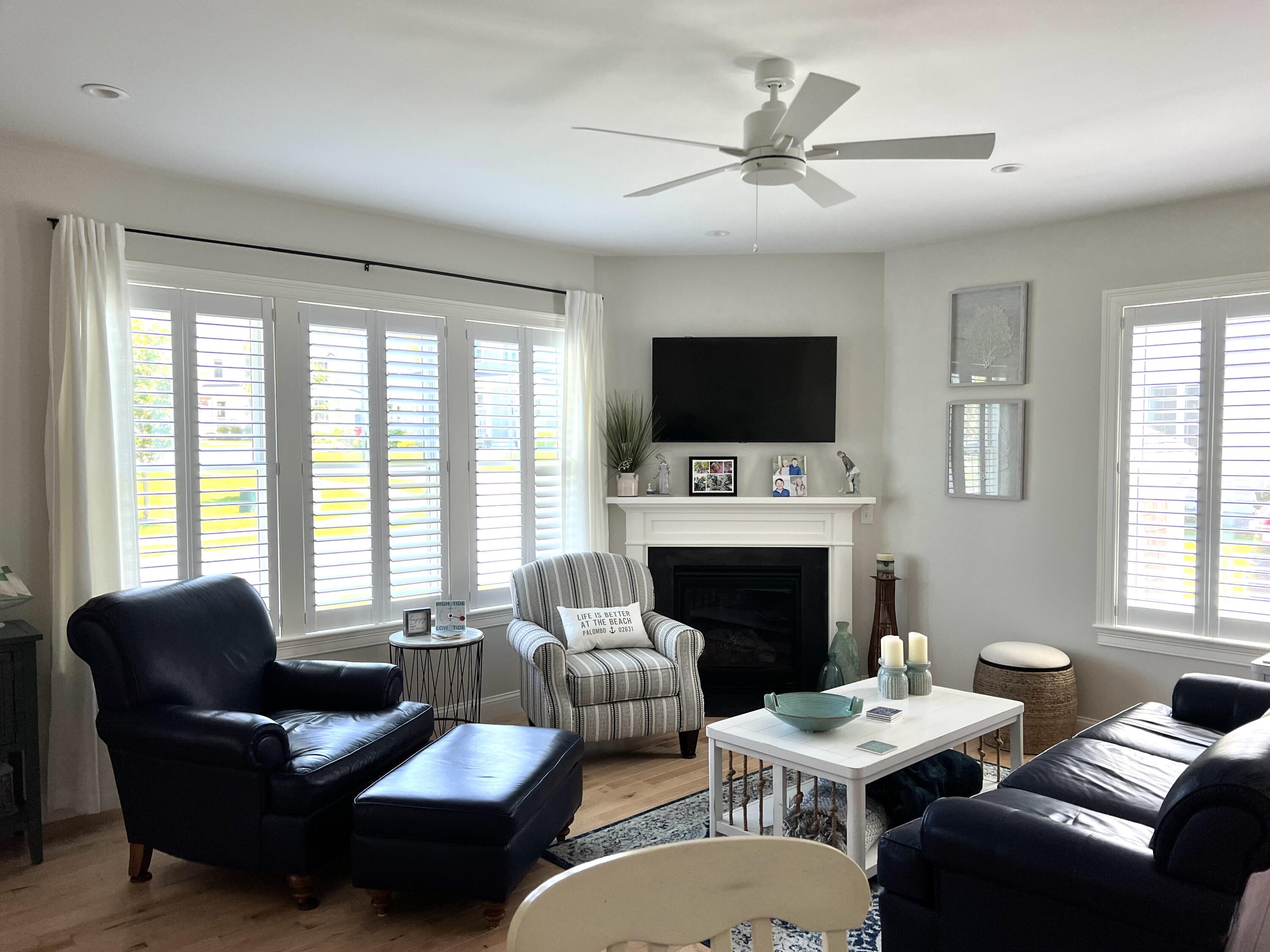 601 Ma Route, Unit 27 Dennis, MA 02638 - Photo 10 of 34 a living room with furniture a fireplace and a flat screen tv