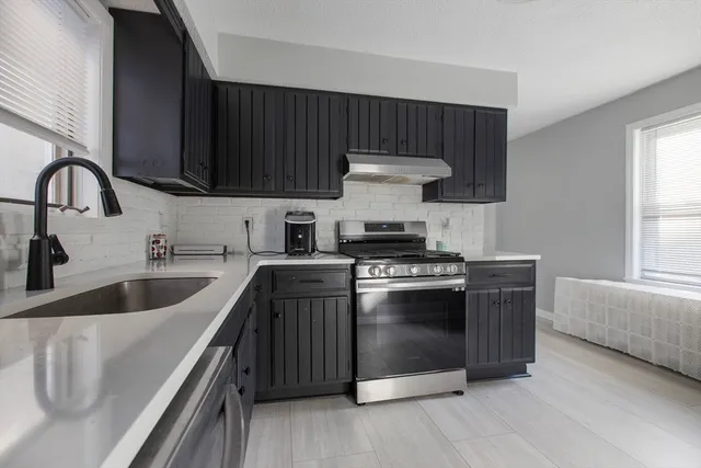 a kitchen with stainless steel appliances a sink and a stove