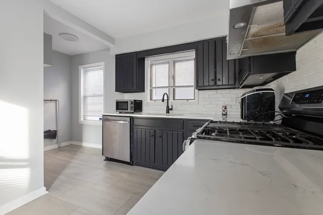a kitchen with a sink stove and cabinets