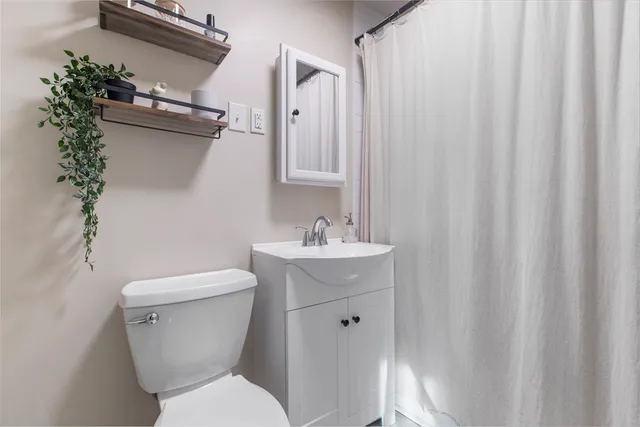 a white toilet sitting next to a bathroom sink
