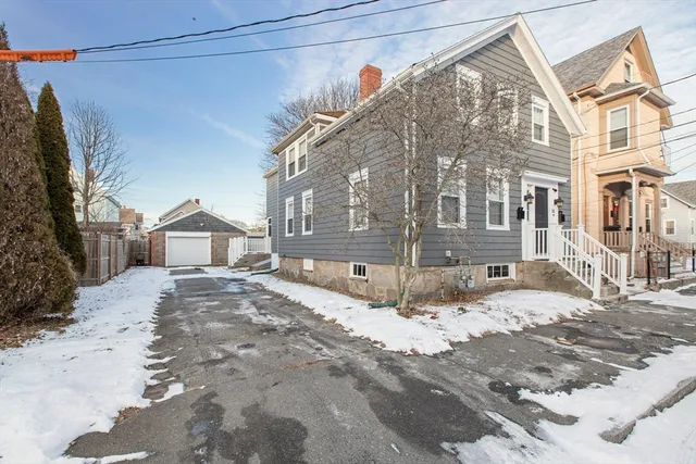 a view of a house with a snow on the road