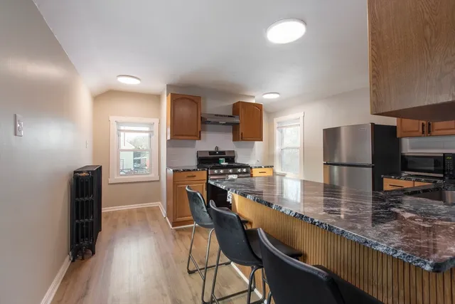 a kitchen with counter top space cabinets and stainless steel appliances