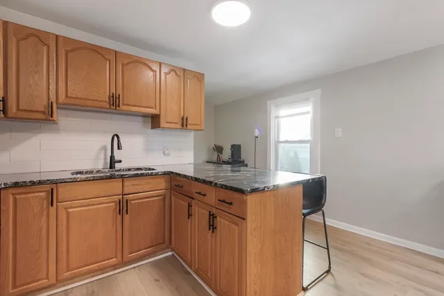 a kitchen with cabinets appliances a sink and a window