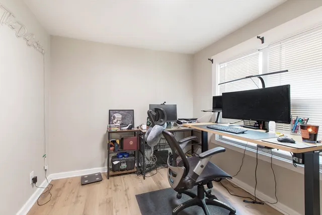 a view of a workspace with furniture and wooden floor