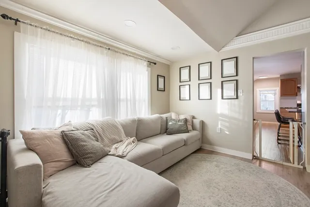 a living room with furniture and large window