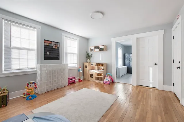 a children room with furniture and a flat screen tv
