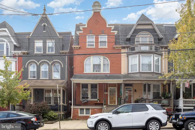 a front view of a building with parking space