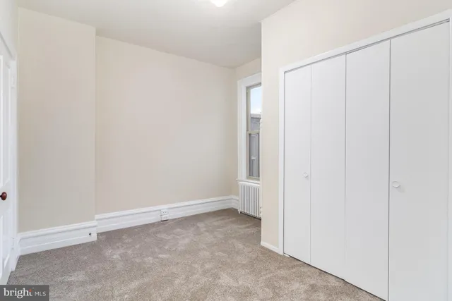 a view of a pathway with a wooden fence