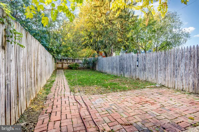 a front view of a house with a yard and table and chairs