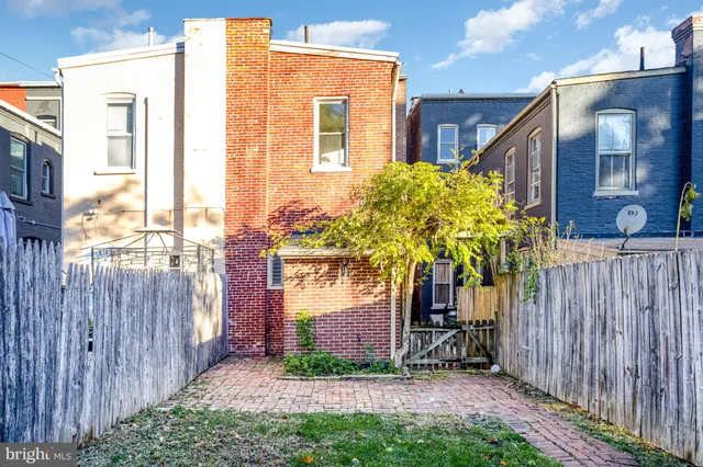 a front view of a residential apartment building with windows and entryway