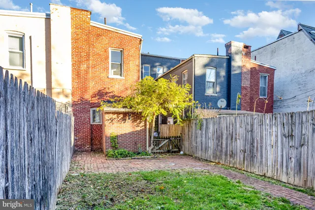 a front view of a residential apartment building with a yard