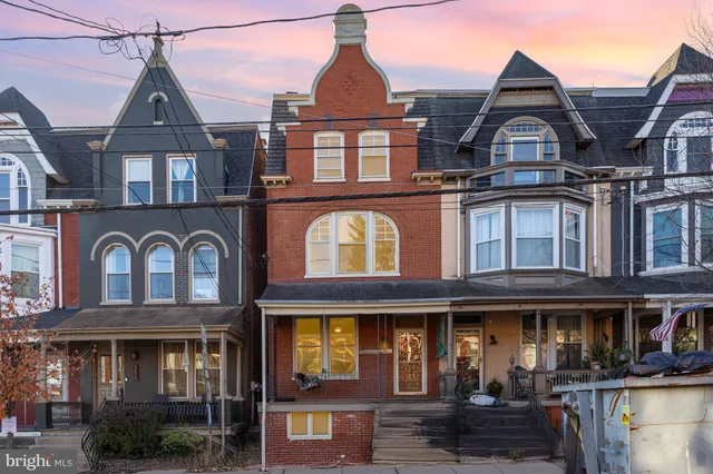 a view of a hallway with paintings on the wall