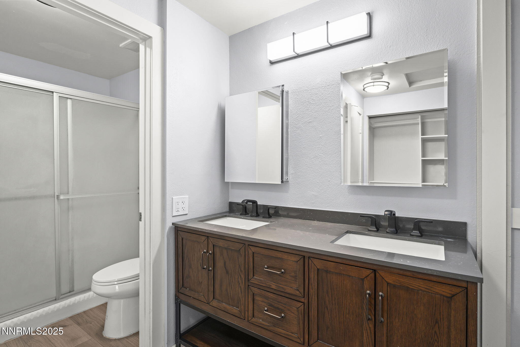1149 Wagon Wheel Circle Reno, NV 89503 - Photo 13 of 19 a bathroom with a granite countertop sink toilet a large mirror and shower