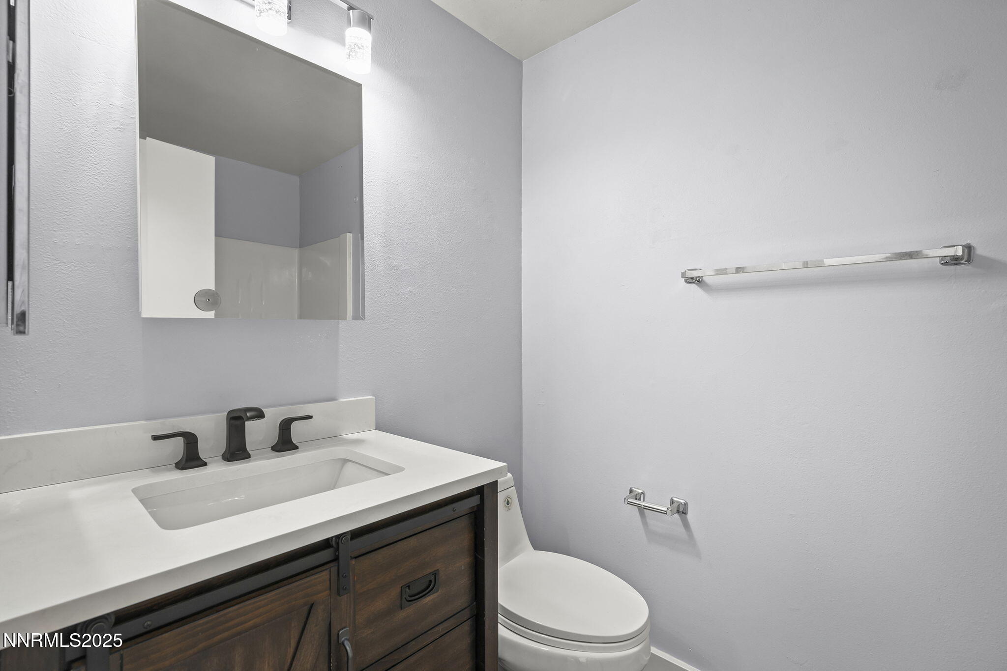 1149 Wagon Wheel Circle Reno, NV 89503 - Photo 15 of 19 a bathroom with a sink mirror vanity and toilet