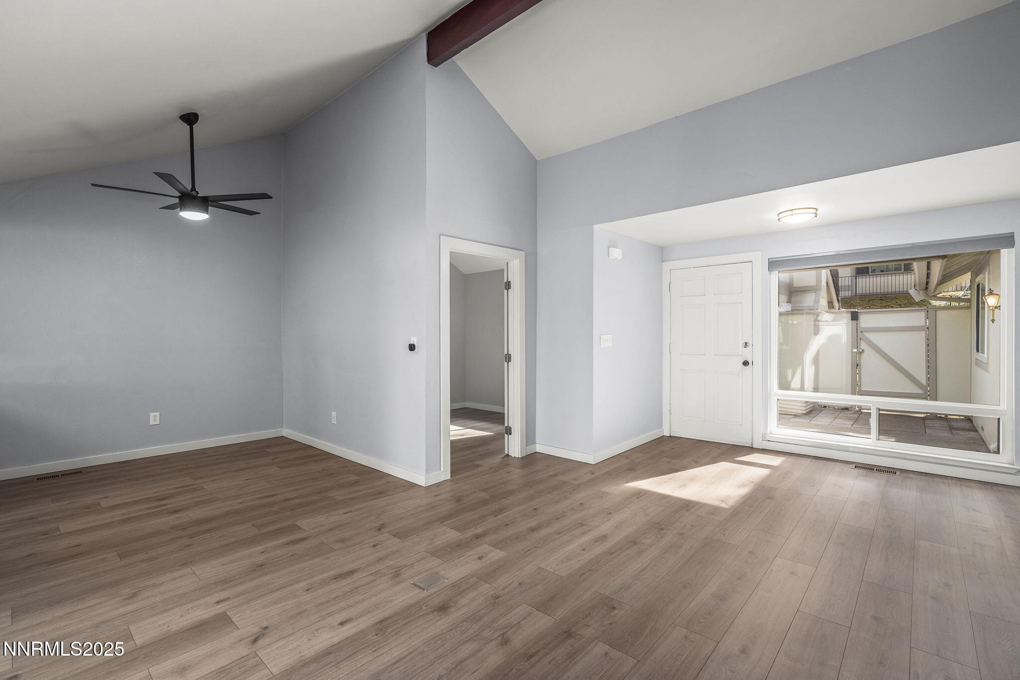 1149 Wagon Wheel Circle Reno, NV 89503 - Photo 6 of 19 an empty room with wooden floor mirror and windows