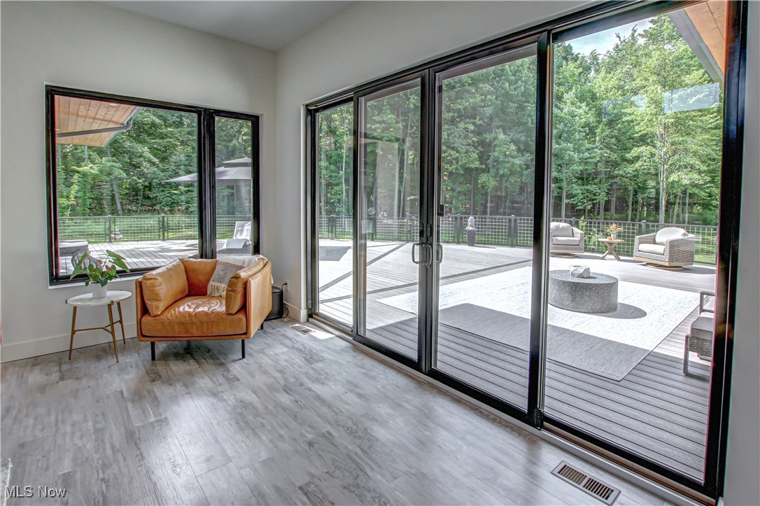 4385 Good Road Seville, OH 44273 - Photo 9 of 50 Great room with plenty of natural light, hardwood / wood-style floors, and a towering ceiling