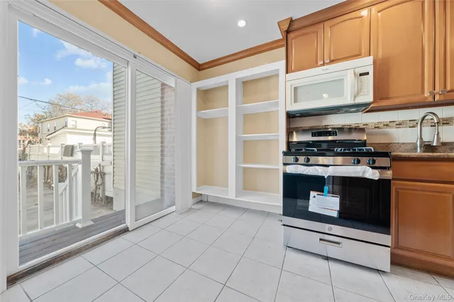 a kitchen with stainless steel appliances granite countertop a stove and a microwave