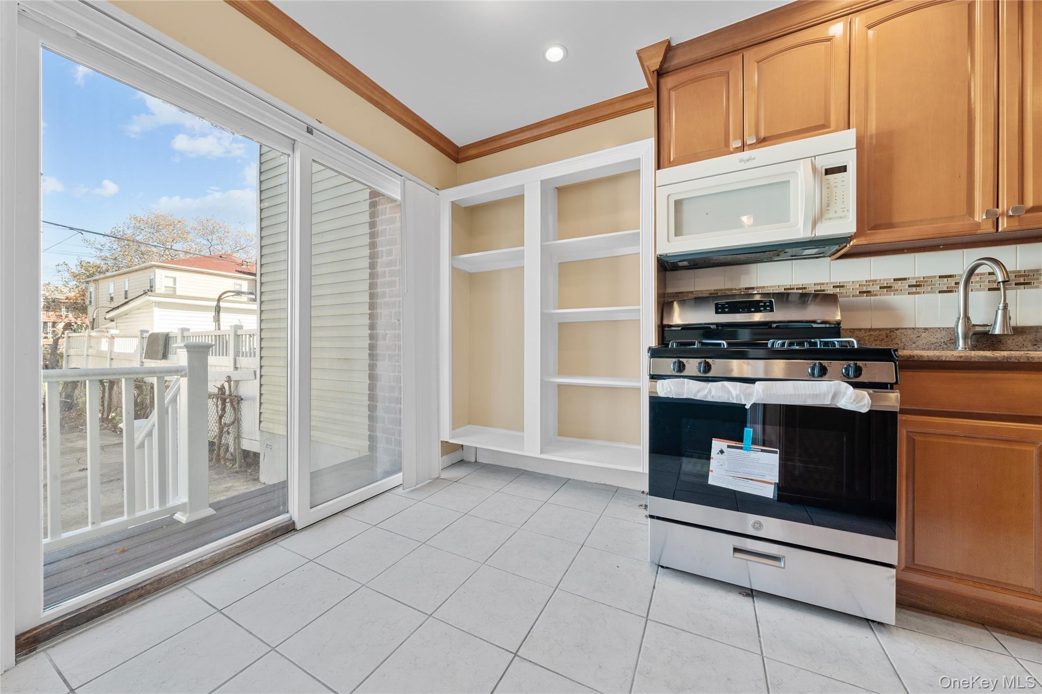 1331 Remsen Avenue Brooklyn, NY 11236 - Photo 15 of 30 a kitchen with stainless steel appliances granite countertop a stove and a microwave