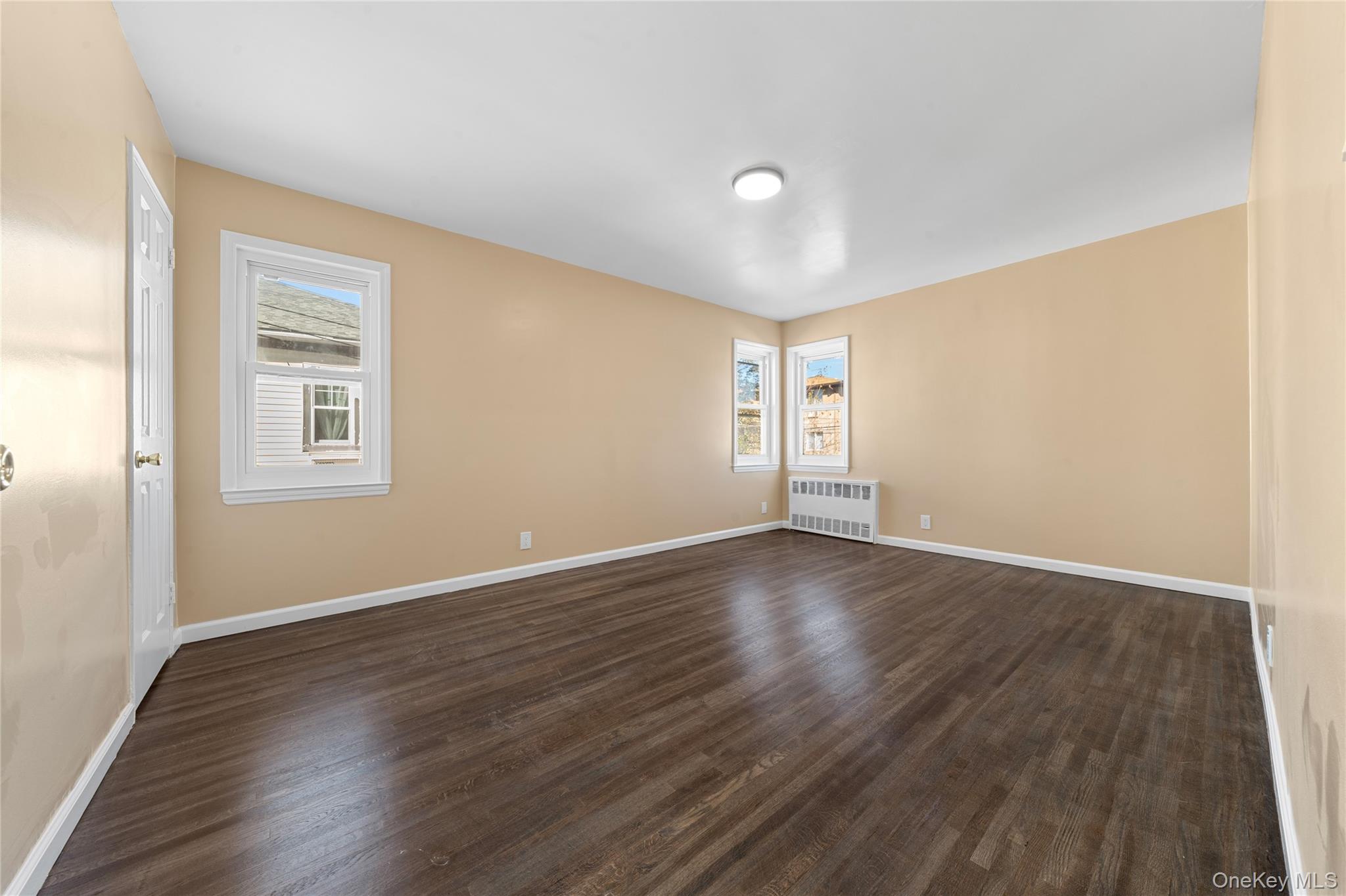 1331 Remsen Avenue Brooklyn, NY 11236 - Photo 19 of 30 a view of an empty room with wooden floor and a window
