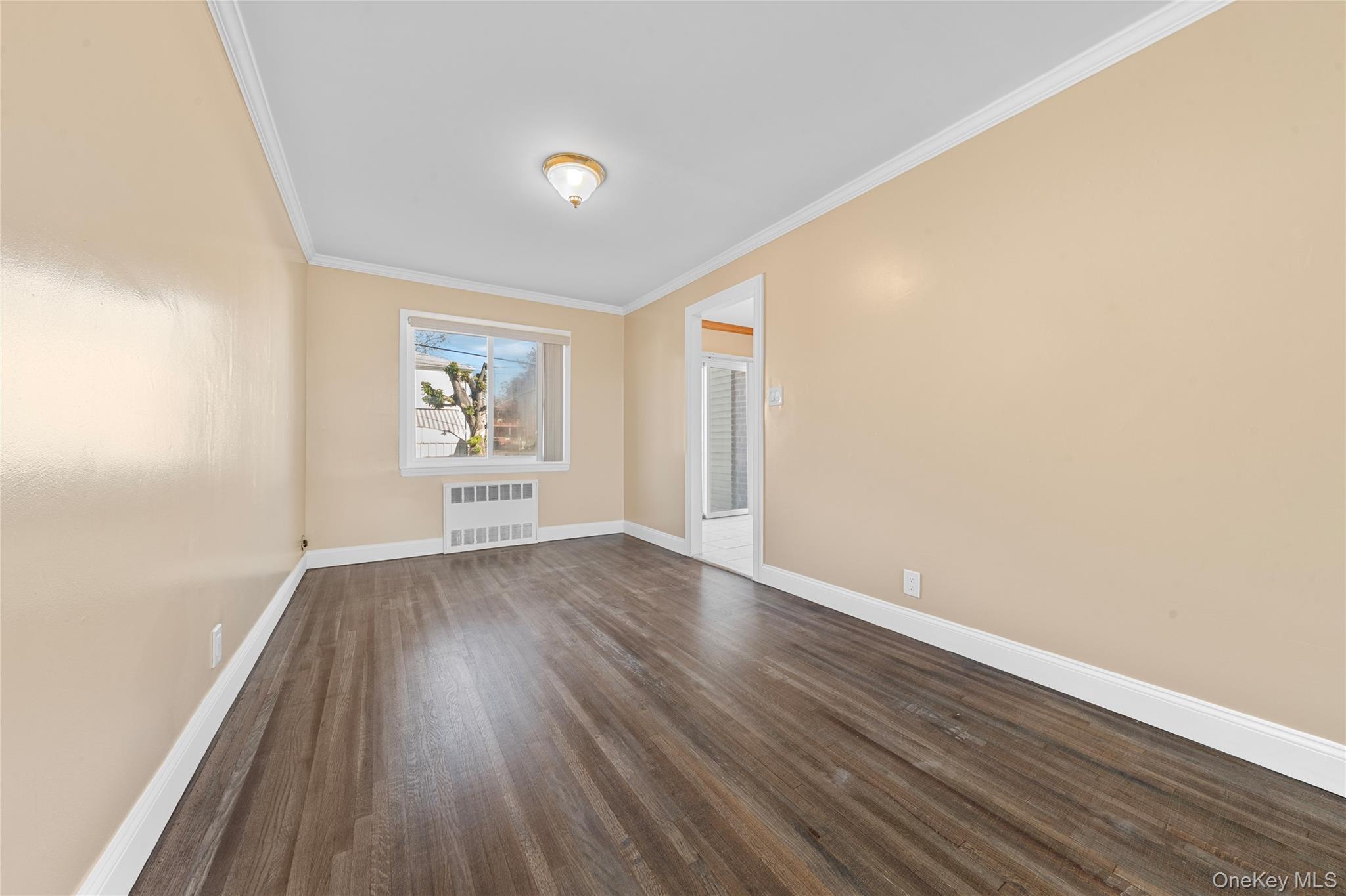 1331 Remsen Avenue Brooklyn, NY 11236 - Photo 21 of 30 an empty room with wooden floor and windows