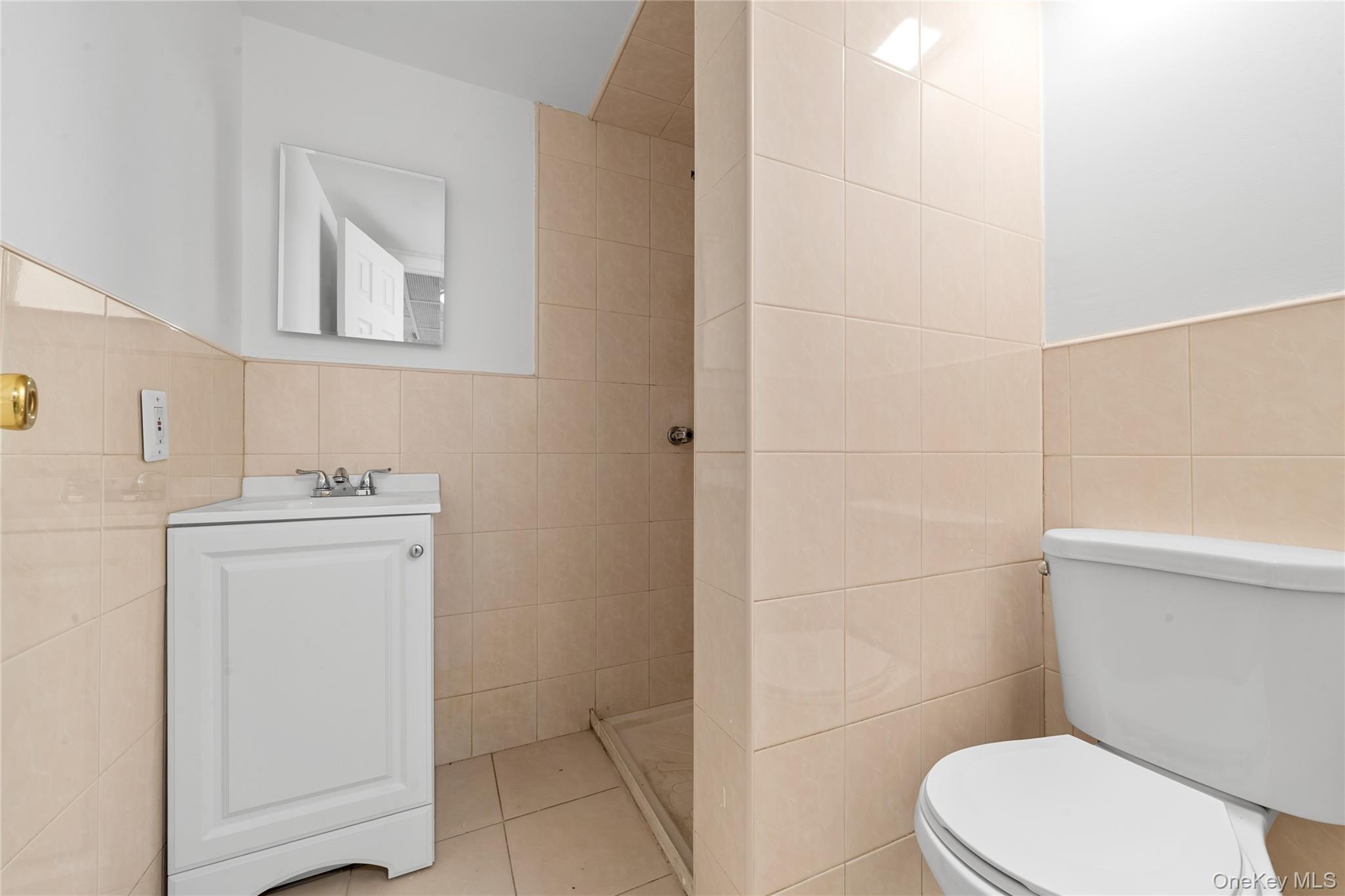 1331 Remsen Avenue Brooklyn, NY 11236 - Photo 22 of 30 a white toilet sitting next to a bathroom sink