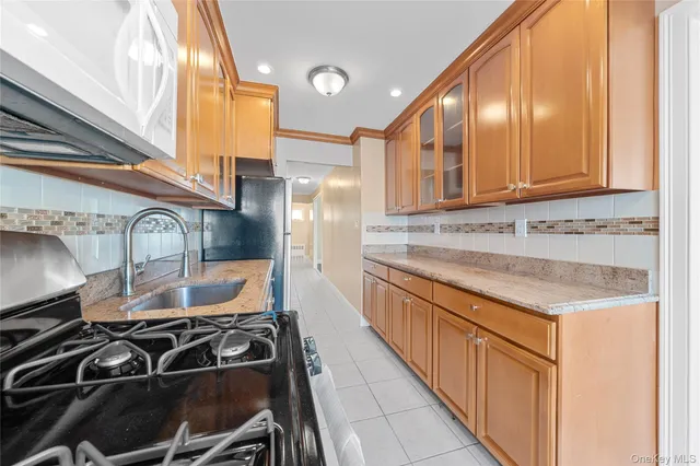 a kitchen with stainless steel appliances granite countertop a stove and a sink