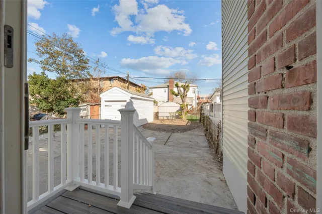 a view of a pathway of a building with wooden fence