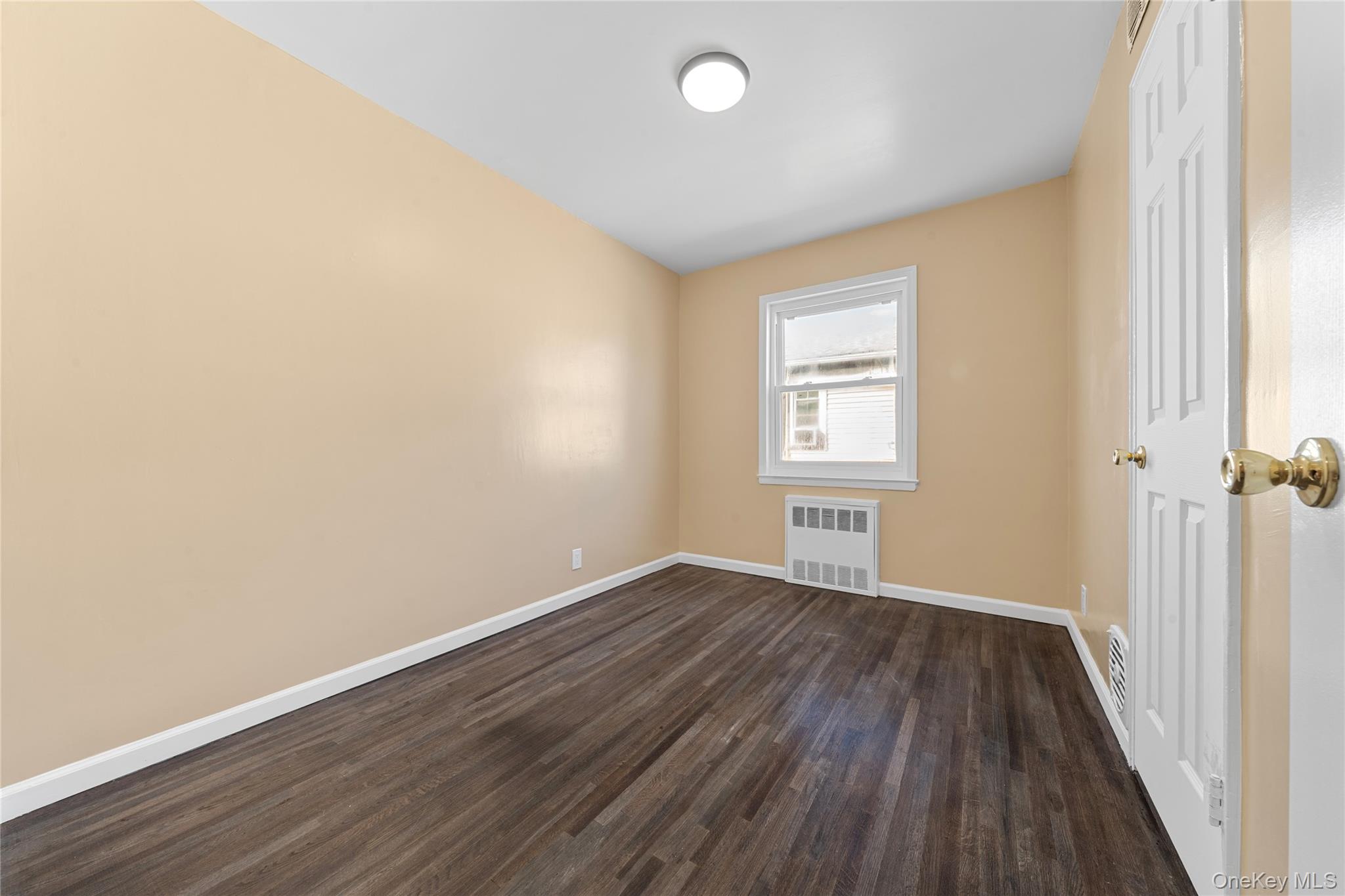 1331 Remsen Avenue Brooklyn, NY 11236 - Photo 8 of 30 an empty room with wooden floor and windows
