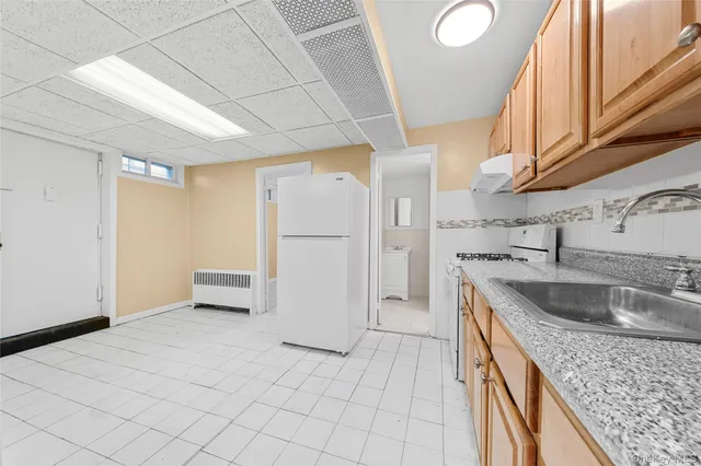 a kitchen with stainless steel appliances granite countertop a sink and a refrigerator